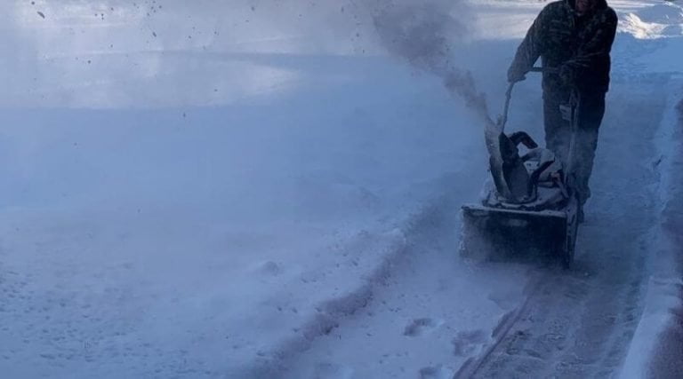 snow blowing a drive way